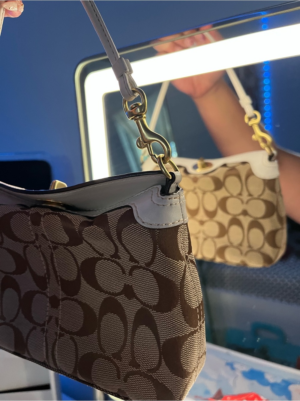 Coach Small Signature Mini Turn lock Shoulder Bag in Brown.